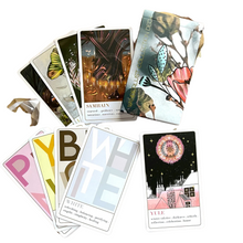 cards fanned out showing samfain, white, yellow, brown, pmink, yule as a reading