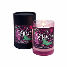 purple glass candle and black sleeve in lilac scent wiht snakes and stars and goddesses on lable