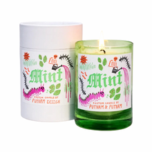 green glass candle wiht sun and catepillars scented in mint 