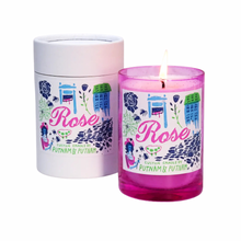 pink glass candle with illustrations of roses, home, joy, and spiderwebs in a rose scent 