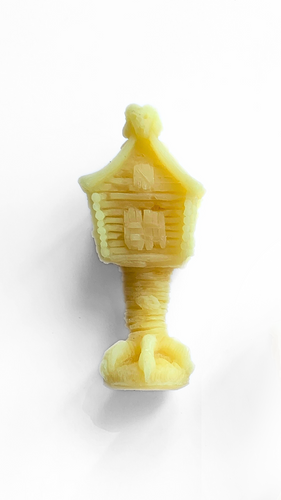 Beeswax candle shaped like Baba Yagas House, featuring intricate details that capture the essence of the mythical witch, perfect for adding a whimsical and mystical element to decor