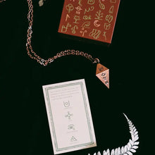 copper pendulum with glyphs