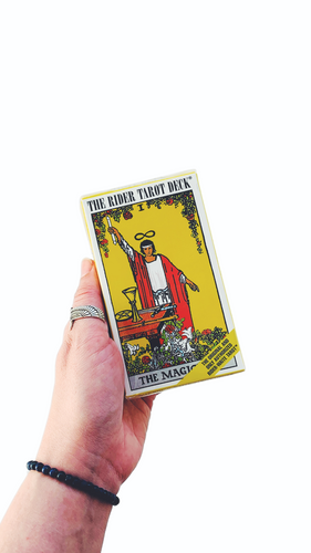 Hand holding the rider-wait tarot deck